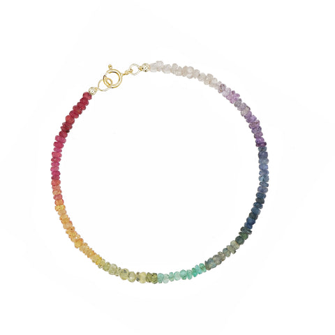 Custom-made fine gemstone bracelet by MARGOVA with a unique rainbow creation. Features stunning variations of Ruby, Sapphires & Emerald, and round clasp made of 585 yellow gold.