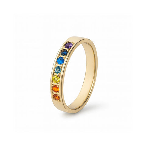A gold ring with a glossy polished surface, featuring a series of colorful gemstones set in a row.