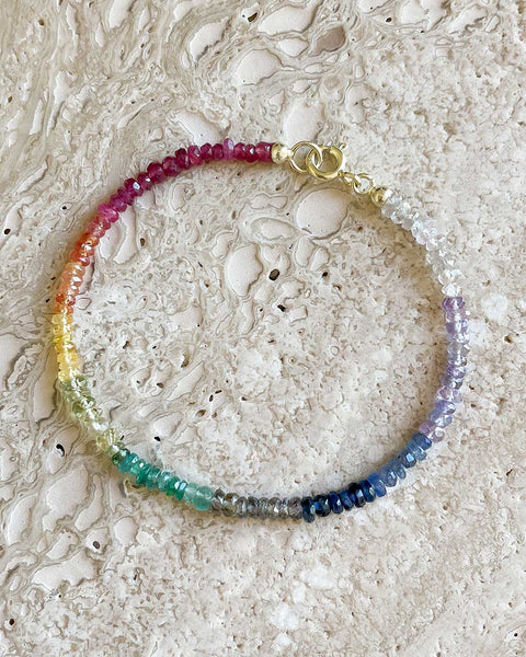 Custom-made fine gemstone bracelet by MARGOVA with a unique rainbow creation. Features stunning variations of Ruby, Sapphires & Emerald, and round clasp.