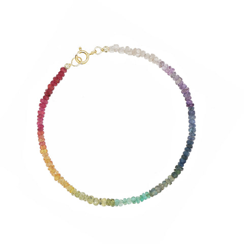 Custom-made fine gemstone bracelet by MARGOVA with a unique rainbow creation. Features stunning variations of Ruby, Sapphires & Emerald, and round clasp made of 585 yellow gold.