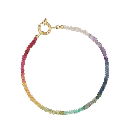 Custom-made fine gemstone bracelet by MARGOVA with a unique rainbow creation. Features stunning variations of Ruby, Sapphires & Emerald, and round clasp made of 585 yellow gold.