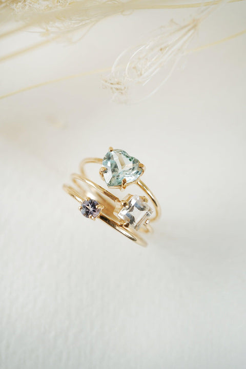 Recycled solid 14k yellow gold ring with Aquamarine Heart 7mm on a 0.9mm signature fine wire band - shown with other gemstone rings.