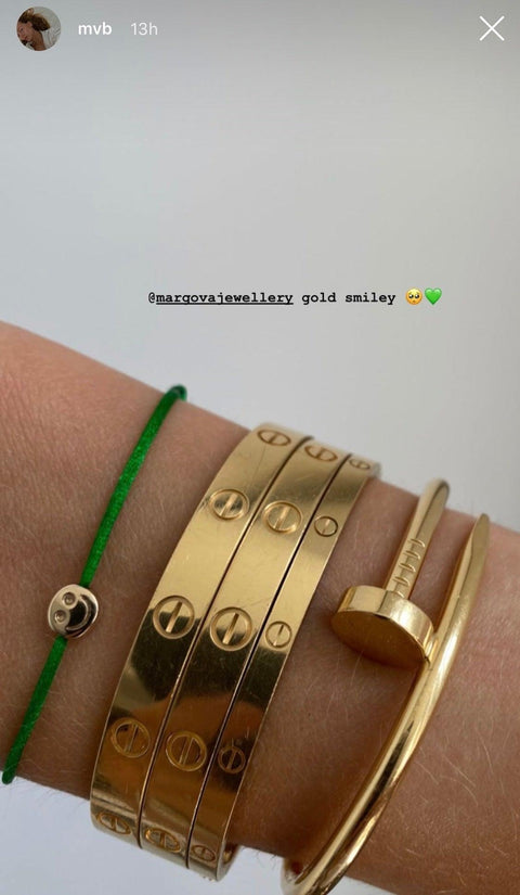 Custom made bracelet with Smiley 14k solid yellow gold charm on colored 1mm satin silk or metallic cord, onesize, handmade in our studio. Model wears armparty with different bracelets.